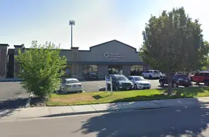 A photo of Eyecare Associates of Nampa building with parked cars in front and a clear sky.
