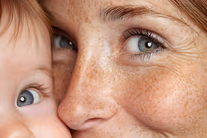Close up of a woman and baby with freckles on their faces