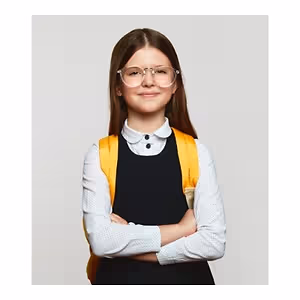 A young girl wearing glasses and a yellow backpack is posing for a picture with her arms crossed.