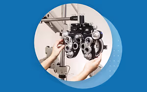 Person adjusting the lenses on an optometrist machine