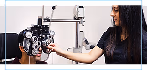 An optician is examining a patient's eyes with a machine