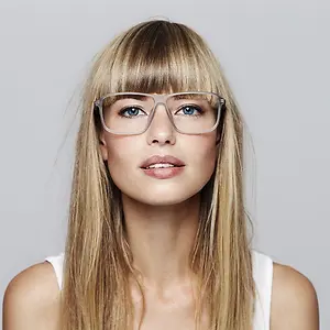 a blonde woman with bangs wearing glasses