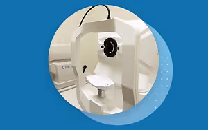 An image of a white CT scan machine with a blue background