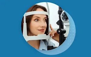 A woman is having her eyes checked by a doctor using an eye examination machine.