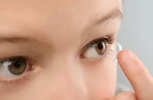 a young girl wearing a lense on her right eye