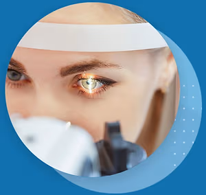 A woman's eye being examined by a doctor with a bright light illuminating her eye