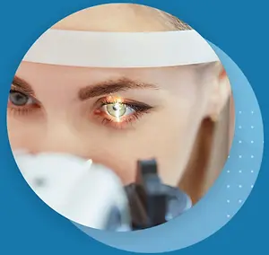A woman's eye being examined by a doctor with a bright light illuminating her eye