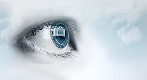 A close-up of a human eye with a blue iris and a blue circle in the middle