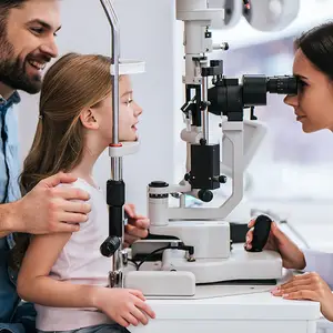 dad with daughter in ophthalmology clinic