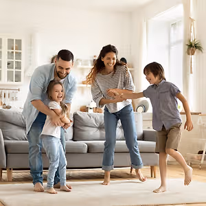 happy family playing funny game having fun together with little son and daughter in modern living room