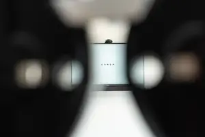 A blurry image of a monitor with the word EGNOM on it, probably from a surveillance camera.