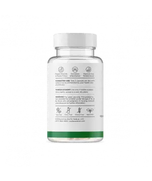 A white bottle with a green border and a white cap is displayed on a black background. The bottle is filled with capsules and has a label that includes text, icons, and a warning.
