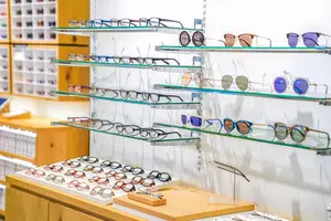 A store with glass shelves with eyeglasses on them