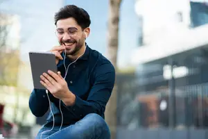 Young man listening to music on his tablet