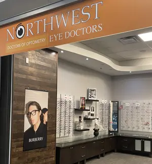 Interior view of Northwest Eye Doctors with a sign, wooden wall, and various displays