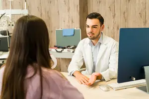 Doctor talking to a patient in a medical clinic office