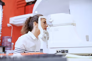 Woman examining her vision with an ophthalmoscope