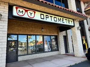 Exterior of the MY Optometry shop with a sign that reads 'MY OPTOMETRY' and a picture of two people wearing glasses.