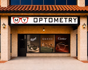 Exterior of an optometry store showcasing luxury brand glasses in the window display