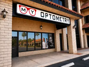 MY Optometry storefront with glass doors and windows, an M Y logo, and a Tom Ford advertisement