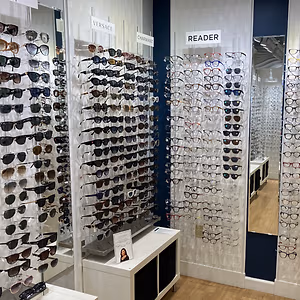 a display of sunglasses and reading glasses in a store
