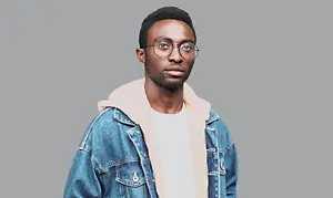 man wearing glasses with denim jacket and white shirt