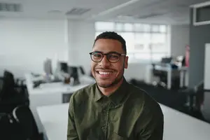portrait of smiling male office worker wearing glasses