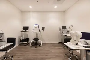A room with medical equipment, a desk, and a chair
