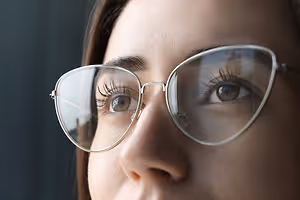 Close up of a woman's face with glasses on.
