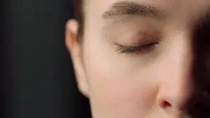 A close up of a woman sleeping with her eyes closed