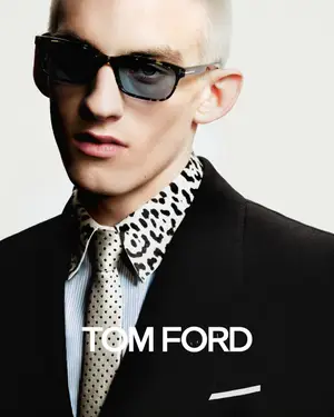 Man in black coat and leopard print collar posing for a Tom Ford advertisement