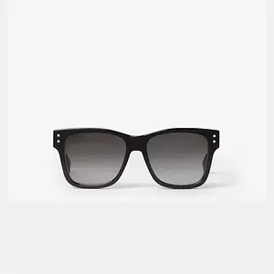 Pair of black sunglasses with dark grey lenses and black frames with gold studs at the corners