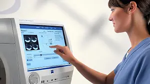 Optometrist reviewing visual field test results on a Humphrey Field Analyzer