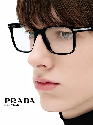 Close-up of a person wearing black Prada eyeglasses