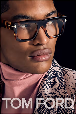 Close-up portrait of a person wearing dark rectangular Tom Ford eyeglasses