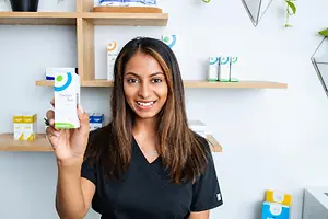 Optometry professional holding a box of Thealoz Duo eye drops