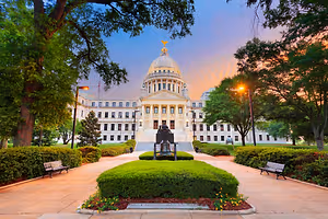 A photo of the Mississippi State Capitol building at sunset