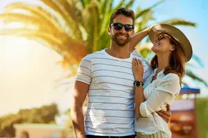 A happy couple with sunglasses from Monji Optometry in Burbank, CA.