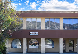The exterior of a building with large windows and a sign reading 'Topa Topa Optometry'