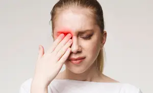 A woman with a headache touching her forehead with her hand