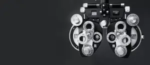 Close-up of an optometrist's eye exam equipment on a black background
