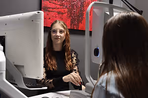 female optician performing eye exam on female patient