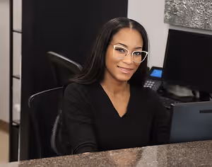 woman wearing white frame eyeglass smiling at the camera