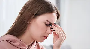 Woman covering her eyes with her hand