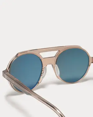 A pair of sunglasses with blue lenses and a rose gold frame