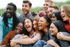A group of people posing for a photo with wide smiles on their faces