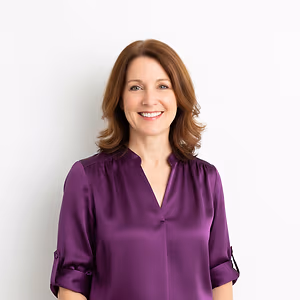 Woman in purple blouse smiling at the camera