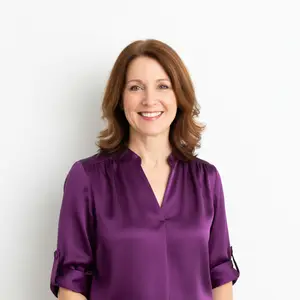 Woman in purple blouse smiling at the camera