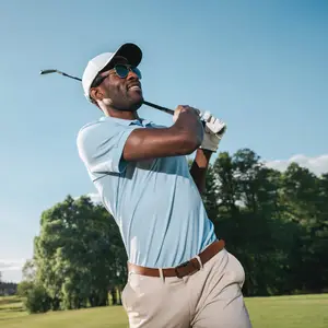 A man playing golf on a sunny day with a golf club in his hand
