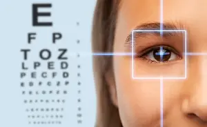 woman looking at eye doctor with eye chart in front of her